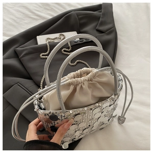 Detailed shot of silver sequin bucket bag with drawstring liner and chain strap