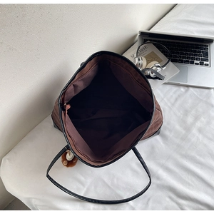 Top view of spacious leopard print tote bag interior with inner zip pocket and laptop