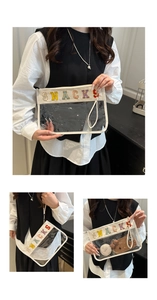 Detail of transparent PVC makeup bag featuring a colorful Chenille patch with SNACKS lettering