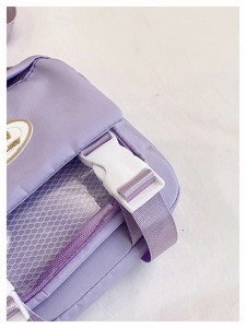 Close-up of lavender oxford fabric bag with white safety buckle and mesh side pocket