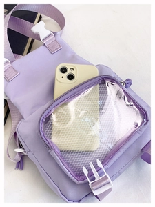 Detail view of purple nylon crossbody bag with transparent honeycomb mesh phone pocket