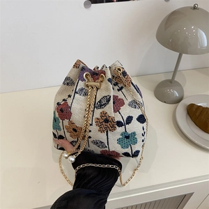 Boho chic floral embroidered bucket bag with pearl drawstring and gold chain strap