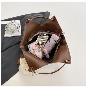 Internal view showing large capacity for umbrella, phone and wallet in brown leather tote