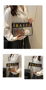 Detail of transparent PVC makeup bag with leopard trim and SNACKS chenille patches
