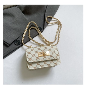 Detail of cream crossbody bag with vintage monogram pattern and gold chain strap