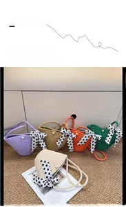 Detailed view of handmade woven straw bags in five colors with pearl clasp and polka dot ribbon