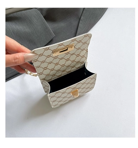 Detail view of the open chain crossbody bag showing the black interior and monogram pattern