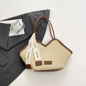 Large straw tote bag with brown leather trim and chic floral ribbon for beach summer