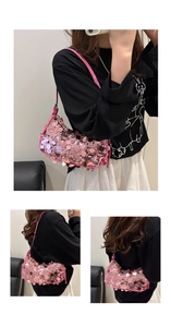 Detailed macro view of pink sequined shoulder bag featuring a stylish silver chain strap