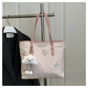 Detailed embroidery of colorful butterflies on pink quilted leather tote bag
