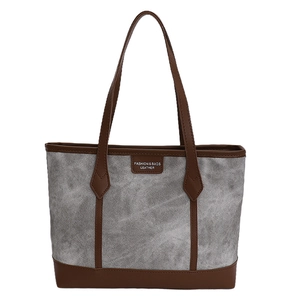Minimalist canvas tote bag with brown leather trim and large capacity for daily commute