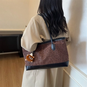 Trendy large leopard print tote bag for women with black leather trim and lion charm