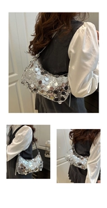 Detail of shimmering silver sequin hobo bag showing metallic texture and fashion design