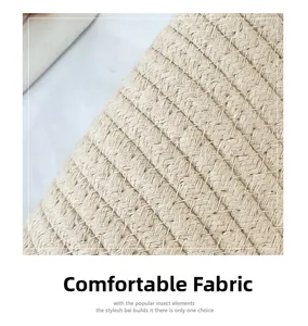Close-up of beige woven fabric texture showing cross-stitch craft on the bucket bag
