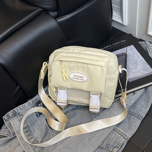 Fashionable cream nylon crossbody bag with multi-pocket design and adjustable strap