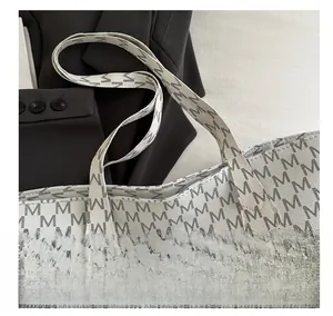 Close-up of comfortable tote bag handles with M-letter pattern and litchi texture