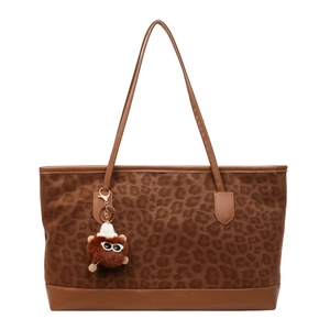 Brown leopard print large tote bag with leather straps and monster charm on white background