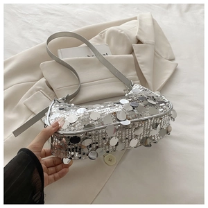 Close-up of silver sequin shoulder bag with metallic reflective texture and slim strap