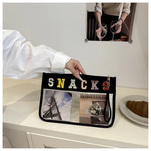 Close-up of translucent PVC cosmetic bag featuring colorful SNACKS towel embroidery