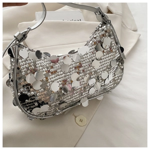 Detailed view of silver sequins and crescent shape on this chic underarm bag