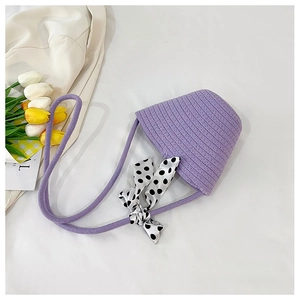 Detail of purple knit bucket hat with polka dot ribbon bow and soft woven texture