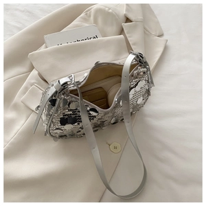 Detail of silver sequin shoulder bag showing spacious interior with cosmetics inside