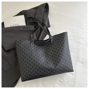 Detailed close-up of charcoal gray tote bag featuring all-over M-letter pattern print