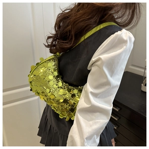 Detail of green sequin crescent bag showing vibrant light reflection and Y2K style