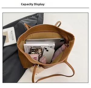 Top view of spacious caramel leather backpack showing interior storage and plush bear charm