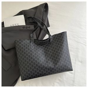 Detail of charcoal gray tote bag with M-letter print and textured PU leather finish
