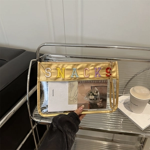 Golden transparent PVC crossbody makeup bag with SNACKS embroidery and wrist strap