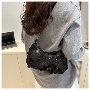 Macro detail of the black sequin material and moon shape on this fashion hobo shoulder bag