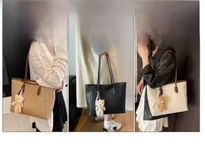 Detailed views of the large lychee grain leather tote bag with plush bear charm