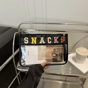 Transparent PVC cosmetic bag with SNACKS embroidery and black leather trim handle