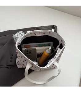 Flat lay of large tote bag with red cherry print showing spacious interior capacity