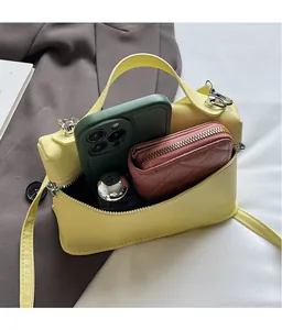Internal view of yellow crossbody bag holding a smartphone and zip wallet