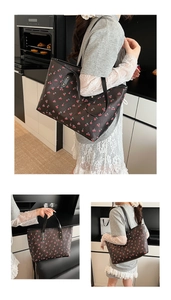 Detail of cute cherry print tote bag with textured finish and durable shoulder straps