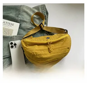 Detail of yellow nylon waist bag showing water-resistant texture and adjustable strap