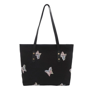 Black tote bag with colorful butterfly embroidery and gold rivets on a white background