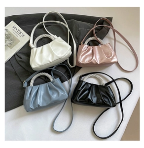 Detail showing four ruched cloud bags with large pearl handles and thin shoulder straps