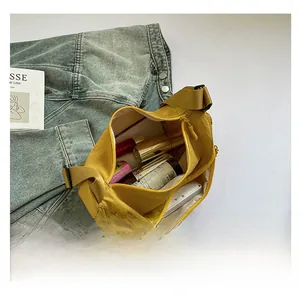 Top view of yellow nylon saddle bag showing interior storage for daily essentials