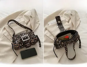 Detail of leopard print shoulder bag with silver rivets and internal storage space