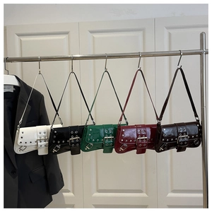 Detailed row of five patent leather Y2K baguette bags with silver studs and buckles