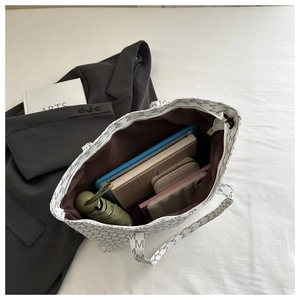 Interior view of tote bag showing large capacity with tablet and daily essentials