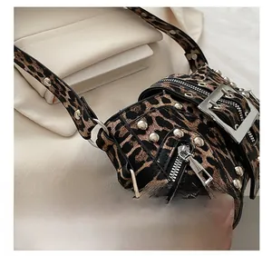 Detail showing leopard print texture with silver studs and metal buckle hardware