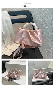 Detail of pink pleated satin bag with pearl handle and detachable shoulder strap