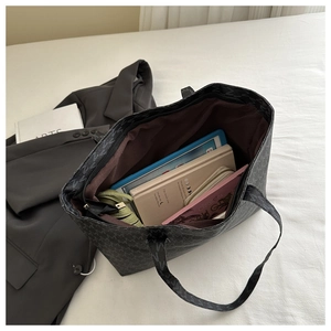 Top view of large tote bag with M-letter monogram pattern showing spacious interior storage