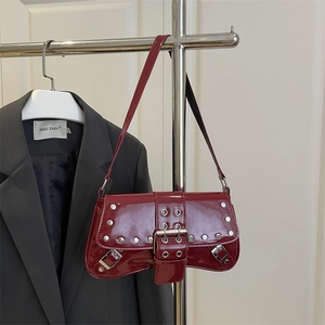 Dark red patent leather shoulder bag with silver studs and buckle in a 2025 Y2K punk style