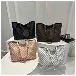 Detailed view of large tote bags in black, brown, pink, and white with M-pattern print