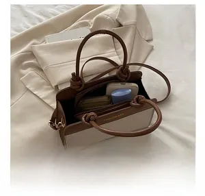 Detail view of large-capacity tote showing interior space for essentials and canvas texture